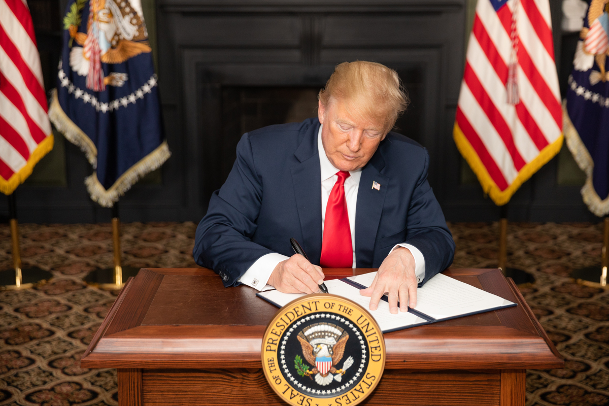President Donald J. Trump signs an EO on Iran Sanctions in the Green Room at Trump National Golf Club Sunday, August 5, 2018, in Bedminster Township…